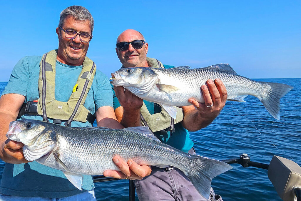 The fishing guide’s clients with their large soft-lure-caught seabass